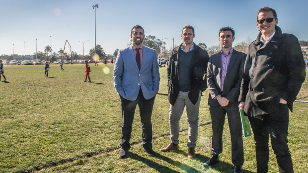 Canberra A-League bid team members Michael Caggiano, Adam Castle, Aaron Walker and Bede Gahan check out some future soccer stars at the Kanga Cup.