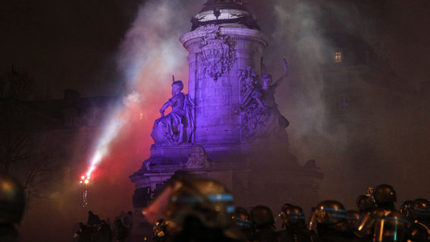 Smoke fills the air as police gather in Republique Square in Paris during a yellow vest protest on Saturday.