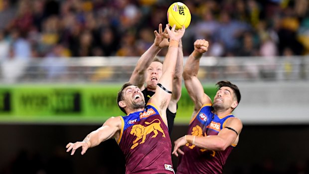 Touch of class: Luke Hodge (left) spoils a marking attempt by Richmond's Jack Riewoldt.