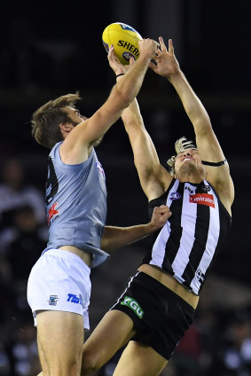 Collingwood's Darcy Moore battles Port's Justin Westhoff in the air.
