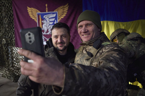 A Ukrainian soldier takes a selfie with President Volodymyr Zelensky, left, during his visit to Sloviansk, Donbas region in Ukraine.