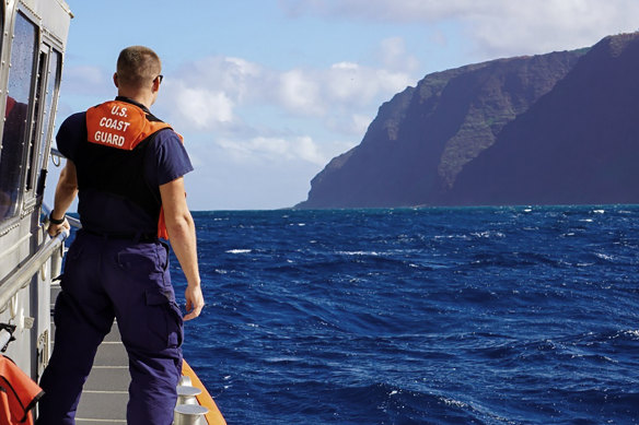 A US Coast Guard cutter moves towards the Na Pali coast during the search for the victims of a helicopter crash on Friday.