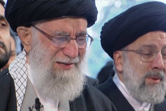Iranian Supreme Leader Ayatollah Ali Khamenei, left, openly weeps as he leads a prayer over the coffin of Qassem Soleimani.