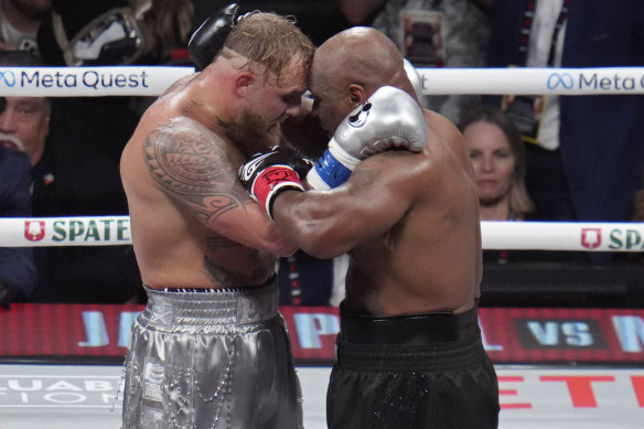 Jake Paul and Mike Tyson embrace after the final round of a fight that many have scorned as a mockery of boxing.