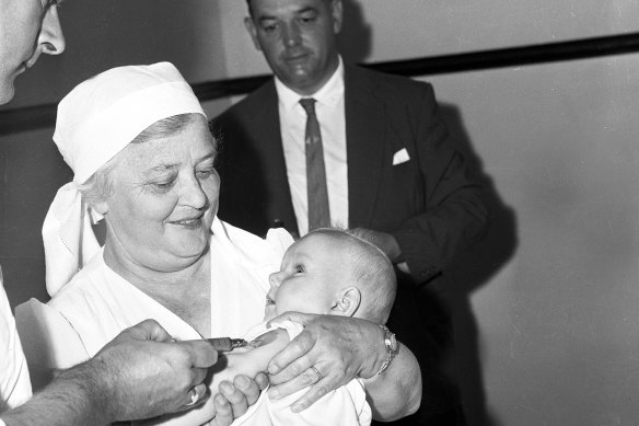 Baby Shaun Livsey receive a new quadruple antigen vaccine for polio at Botany Town Hall, Sydney, 23 February 1961.