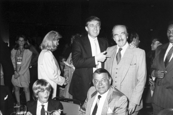 Donald Trump points to his father, Fred Trump at Trump Plaza Hotel, when Donald Trump jnr (front left) was still a child.
