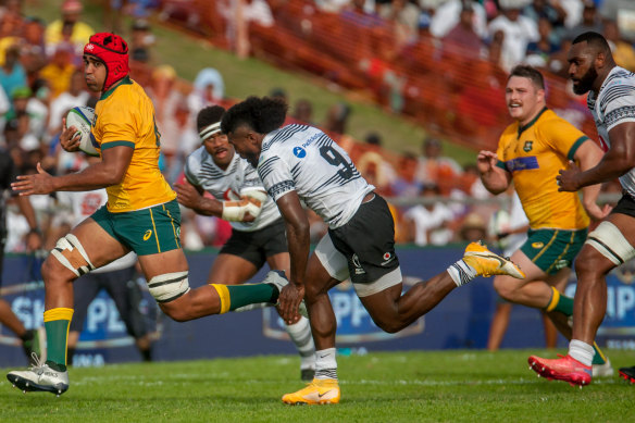 Australia A’s Langi Gleeson leaving Fijian defenders in his wake during the Pacific Nations Cup.