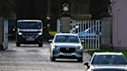 Unmarked vehicles drive away from the gates of the Royal Lodge, Andrew Mountbatten-Windsor’s former residence in Windsor Great Park.