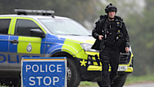 Armed police maintain road blocks and security checks around RAF Fairford.