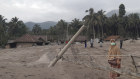 A woman walks in an area affected by the eruption of Mount Semeru in Lumajang, East Java.