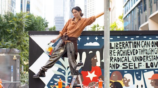Aretha Brown with her new mural in Collins Street.