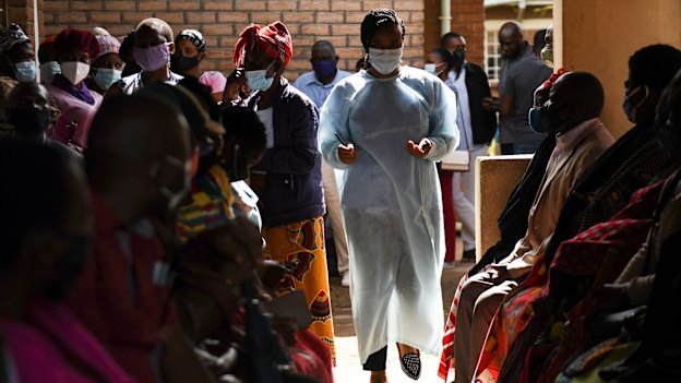 Numbers are handed out to people waiting to receive the AstraZeneca COVID-19 vaccine at Ndirande Health Centre in Blantyre Malawi.