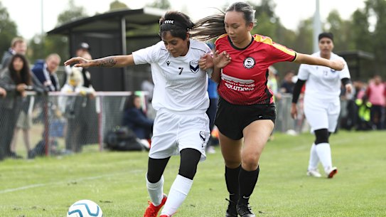 Nilab (left) of the Afghan women’s team  keeps possession in their first Australian match on Sunday.
