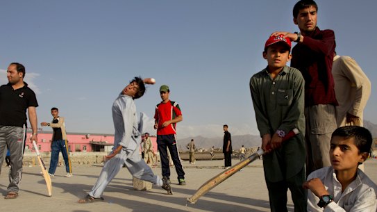 An Afghan cricket player bowls  during a neighborhood cricket game June 15, 2011 in Kabul. 