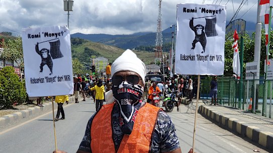A protester hold posters that read "We are monkeys, monkeys want to be separated from Indonesia", during rally in Abepura, Papua province, Indonesia. 
