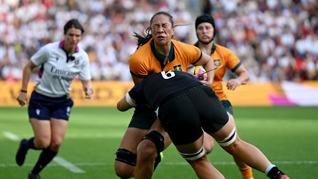 Siokapesi Palu of Australia is tackled by Morwenna Talling of England during the Women’s Rugby World Cup 2025 Pool A match between England and Australia at Brighton & Hove Albion Stadium.