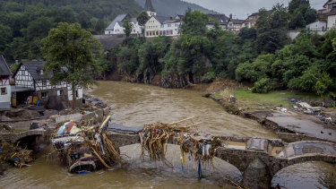 Debris hangs on a damaged bridge over the Ahr River in Schuld, Germany.