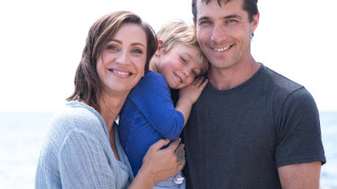 Ami Summers with her husband Dave McCarthy and their son Indy on the beach where they now live in Mornington. 