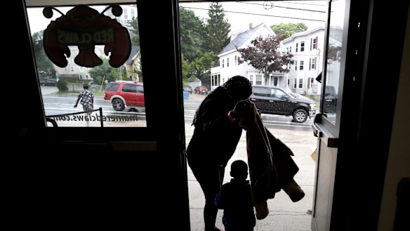 A migrant woman and young boy prepare for rain outside the Portland Exposition Building in Portland where they are housed.