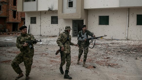 Fighters of Libya's recognised government fire at LNA troops in Salah al-Din, Tripoli in February.