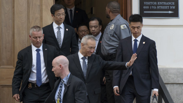 China's Vice-Premier Liu He waves as he leave trade talks in Washington on Thursday.