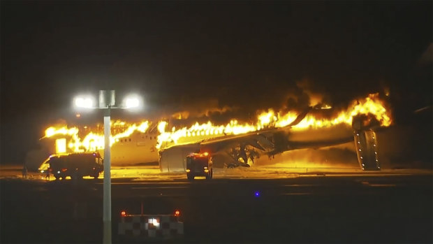 The Japan Airlines Airbus A350 ablaze on the tarmac in Tokyo.