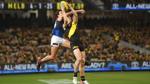 Hit and miss: Marty Hore attempts to spoil a Jack Riewoldt mark.
