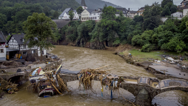 Debris hangs on a damaged bridge over the Ahr River in Schuld, Germany.