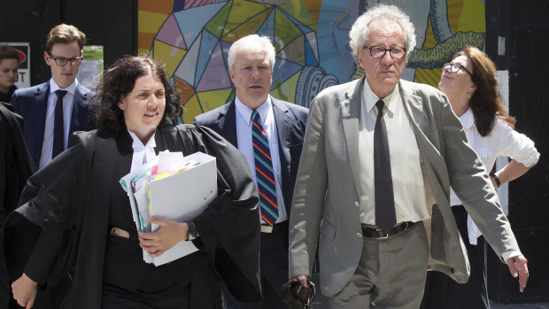 Geoffrey Rush heads into court with his legal counsel on Wednesday.
