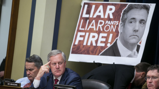 A poster on display during Michael Cohen's testimony to Congress.