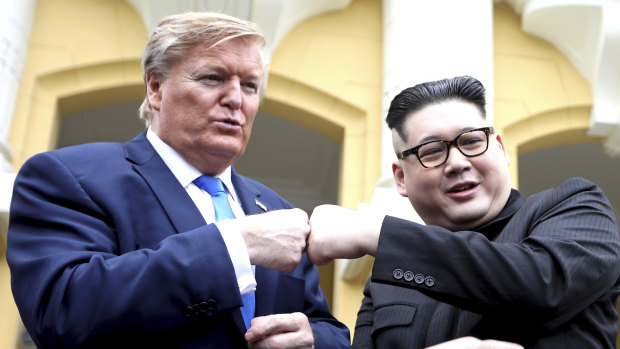 U.S. President Donald Trump impersonator Russell White, left, and Kim Jong-un impersonator Howard X pose for photos outside the Opera House in Hanoi, Vietnam.