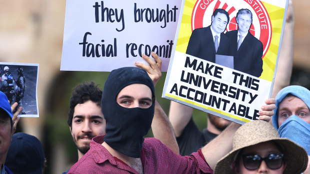 Students hold placards demanding transparency from the University of Queensland. 