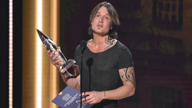 Keith Urban accepts the award for entertainer of the year at the 52nd annual CMA Awards in November. 