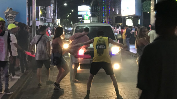 Young, drunk Australian revellers stop traffic on Jalan Legian, Kuta, outside some of the strip's many night clubs. 