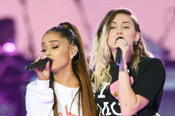 Ariana Grande and Miley Cyrus perform at the One Love Manchester in 2017.