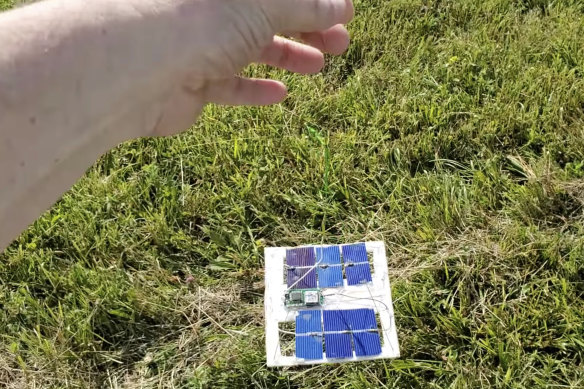 Tom Medlin shows electronics attached to a pico balloon in a field near Collierville, Tennessee.