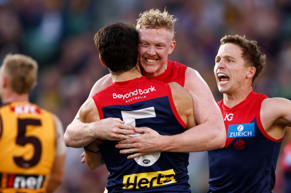 Christian Petracca and Clayton Oliver embrace.