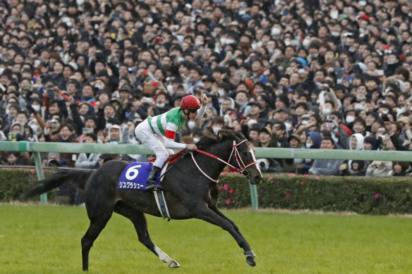 Damian Lane rides Lys Gracieux to victory in Japan’s Arima Kinen in 2019.