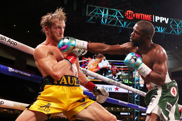 Floyd Mayweather and Logan Paul go at it in the ring in an exhibition match in 2021.