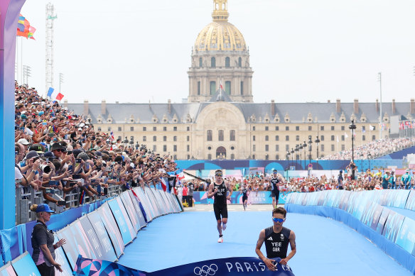 Alex Yee of Great Britain crosses the finish line to win gold during the men’s Individual triathlon.