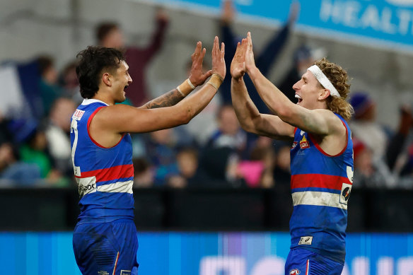 Jamarra Ugle-Hagan (left) and Aaron Naughton of the Bulldogs celebrate.