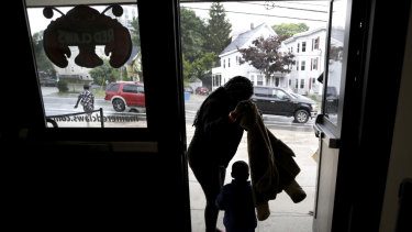 A migrant woman and young boy prepare for rain outside the Portland Exposition Building in Portland where they are housed.