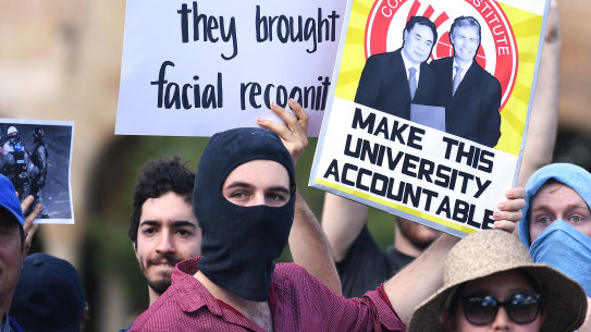 Students hold placards demanding transparency from UQ at Wednesday's protest.