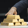 Venezuelan President Nicolas Maduro touches gold bars at a press conference  in Caracas in 2018.