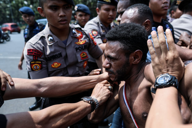 Police block Papuan protesters in Jakarta on August 22.