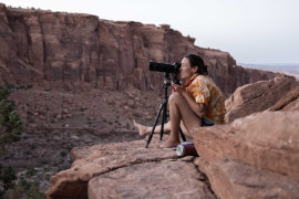 Photographer Krystle Wright takes stationary images of her lighting design on a Long Canyon cliff face.