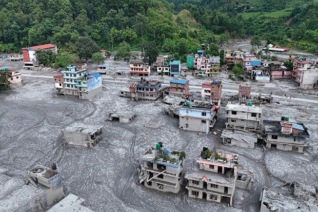 NUWAKOT, NEPAL - AUGUST 28: An Aerial view shows debris and mud covering settlements following flash floods on August 28, 2026 in DevGhat village, Nepal. Authorities said the flash floods were triggered after a mass of ice, mud and rock collapsed into a Himalayan river near the Nepal-China border, leaving hundreds dead or missing and causing widespread damage in affected districts. Authorities continued the gruelling search for victims, many buried under metres of mud, as both China and Nepal issued fresh flooding alerts. (Photo by Ritesh Shukla/Getty Images)