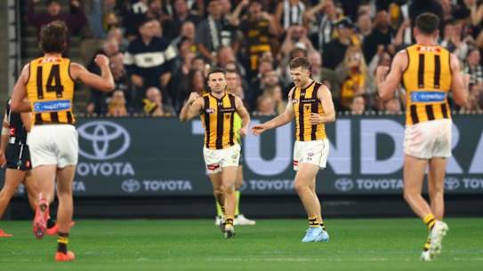 Dylan Moore of the Hawks celebrates after he kicked a goal on the siren for the match to end in a draw.