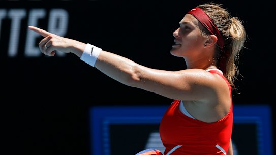 Aryna Sabalenka celebrates after defeating Wang Xinyu .