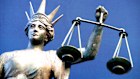 A statue holding the scales of justice outside a court in Queensland.